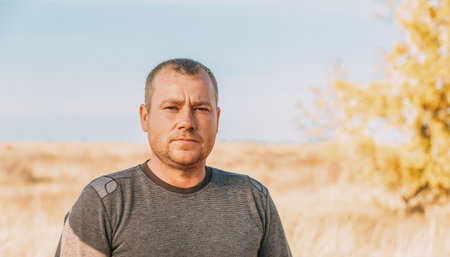 Friendly unshaven adult man outdoors portraitの写真素材
