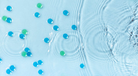 Abstract water, cosmetic background with waves and ripples and glass granules. Concept of therapeutic moisturizing cosmeticsの写真素材