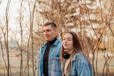 A couple in motion walks in the park in spring or autumn, happy lifestyle conceptの写真素材