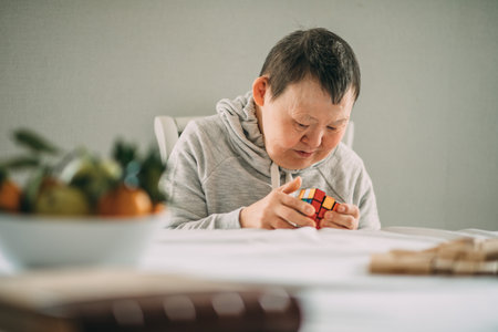 Empowering Development Through Play: Elderly Woman with Down Syndrome Explores New Horizonsの写真素材
