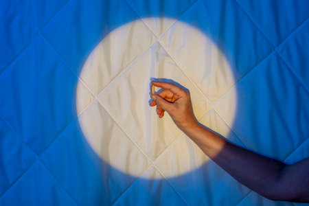 Sleeping capsule, hand in moonlight on a blanket, Melatonins Fight against Insomniaの写真素材