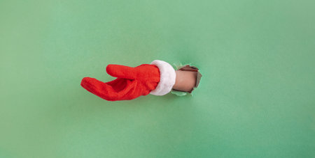 Merry Moments: Santas Hand Extends to Share a Christmas Surpriseの写真素材