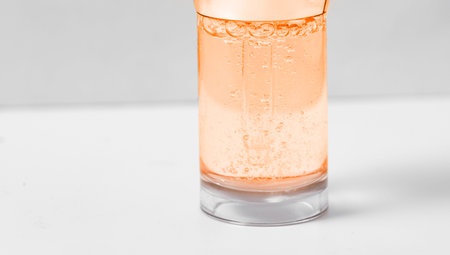 Hyaluronic acid in glass bottle on white background close-up, Liquid gel or serum bubbles, Medicine and Pharmacology. Beauty skin care concept Beauty and spa.の写真素材