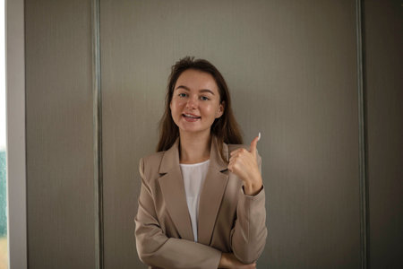 A smiling businesswoman. A small business entrepreneur stands with her arms folded in her breast,...