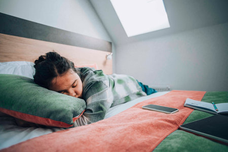 study overload, featuring a student who has collapsed into sleepの写真素材