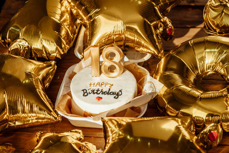 Shining balloons and a bespoke birthday cake center the frame