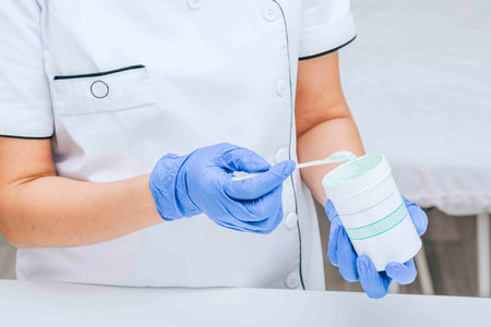 cosmetologist prepares a special dermatological formula, setting the stage for a patients facial rejuvenation sessionの写真素材