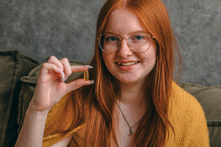 disciplined approach to health, woman preparing her vitamin doses, emphasizing role of preventive...