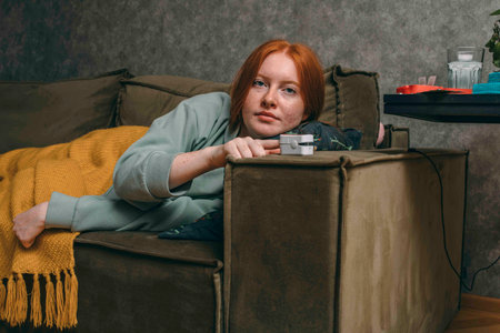 self-care and vigilance is portrayed as a woman checks her oxygen levelsの写真素材