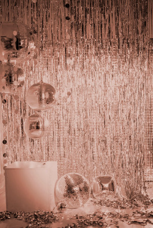 Shiny disco balls and foil fringe curtain indoors, toned in mocha colors