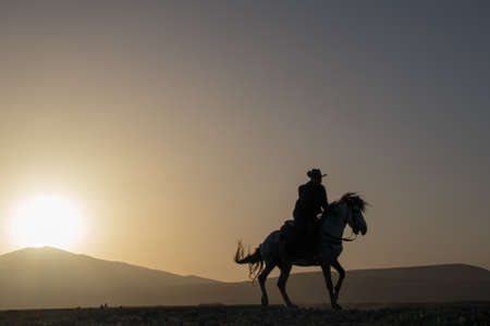 silhouette man riding horseの写真素材