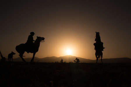 silhouette man riding horseの写真素材