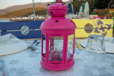 red lantern for romantic dinner on the sea-side tableの写真素材