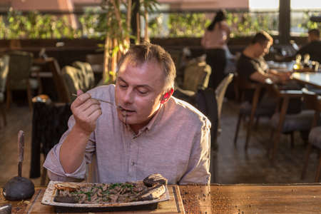A man eating greedily at the steak houseの写真素材
