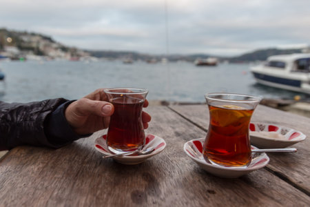 two thin specific cups of tea waiting to be drink on wooden table