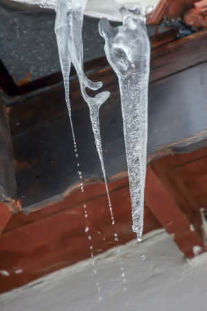 dangling ice that creates great danger in winterの写真素材