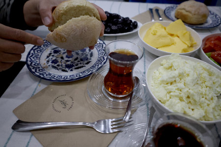 Breakfast . Morning breakfast with cheese, olives, jam, tomatoes, cucumbers, butter, bread and teaの写真素材