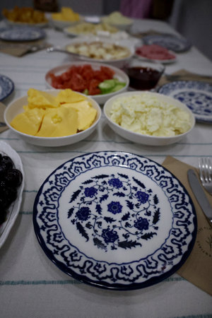 Breakfast . Morning breakfast with cheese, olives, jam, tomatoes, cucumbers, butter, bread and teaの写真素材