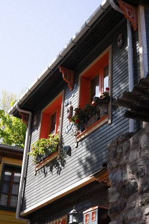 Wooden House with Flower Boxes and Ornate Detailsの写真素材