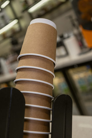 Stack of Kraft Paper Coffee Cups in Cafe Environmentの写真素材