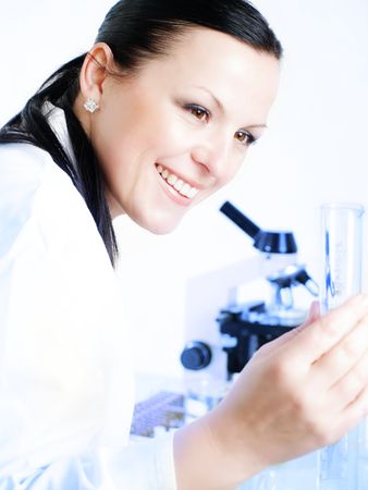 Closeup of a female researcher holding up a test tubeの写真素材