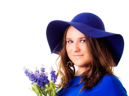 beautiful woman in hat holding lavender flower over white backgroundの写真素材