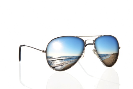 sunglasses with beach and sea reflection over white backgroundの写真素材