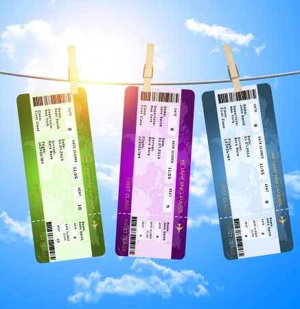 boarding pass tickets hanging on clothesline isolated over blue skyの写真素材