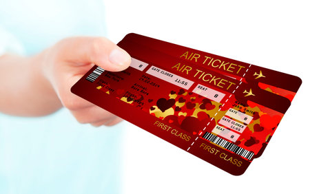  valentine fly tickets holded by hand isolated over white background. Focus on tickets