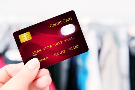 hand holding credit card in the shop. focus on cardの写真素材