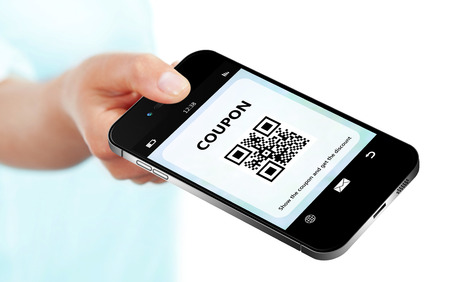 hand holding mobile phone with discount coupon isolated over white backgroundの写真素材