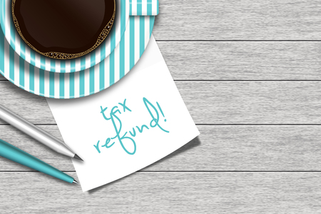 note with tax refund text, coffee, and stationery lying on wooden deskの写真素材
