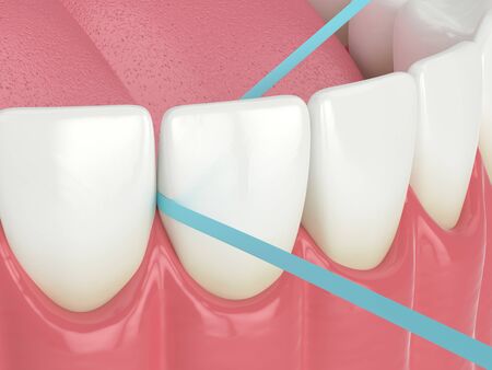 3d render of jaw with dental floss over white backgroundの写真素材