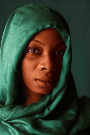 A gorgeous portrait of a young Nigerian lady embodying the African Traditional Heritage in a modern era in Lagos with her green scarfの写真素材