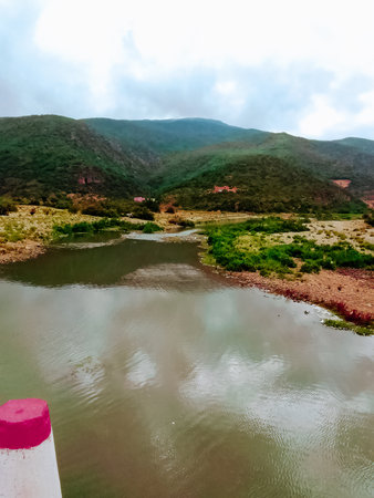 Landscape of a small lake in front of a mountain with cloudy skyの写真素材