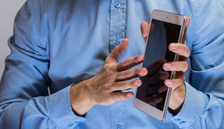 Close up of man hands holding white tablet pcの写真素材