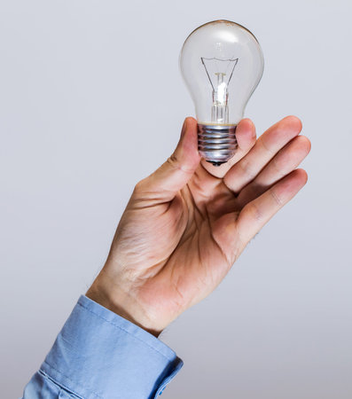 Close up of man hand with light bulbの写真素材