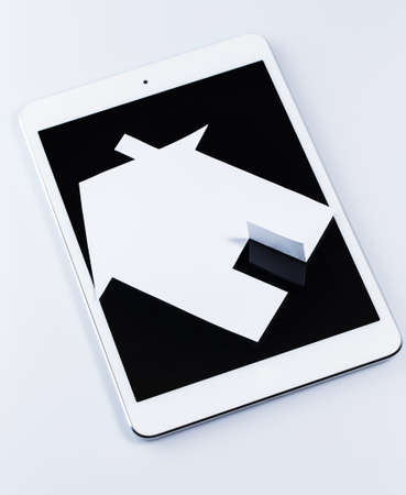 White tablet pc and paper houseの写真素材