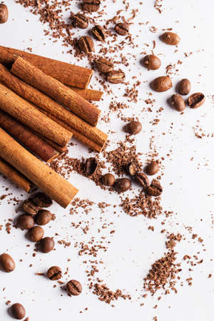 Close up of cinnamon sticks, coffe beans and particles of chocolate の写真素材