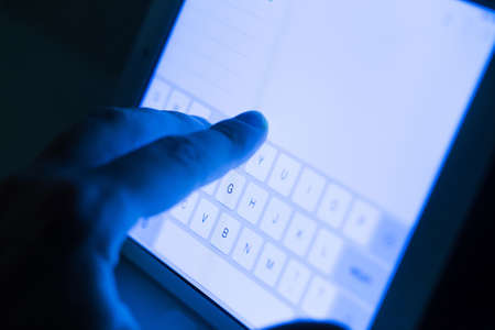 Close up of hand and tablet pc displayの写真素材