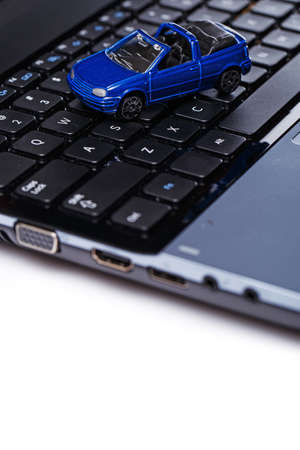 Toy car over laptop keyboardの写真素材