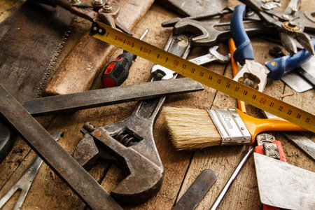Different industrial tools over wooden surface