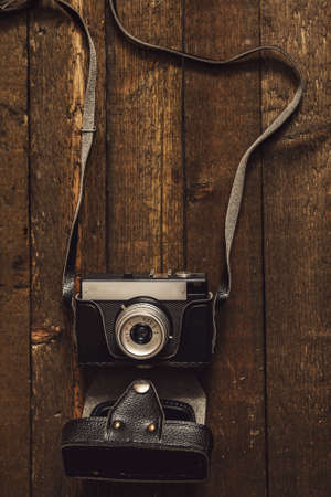 Retro photo camera on wooden surfaceの写真素材