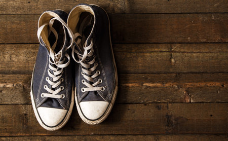 Dirty gumshoes on wooden backgroundの写真素材