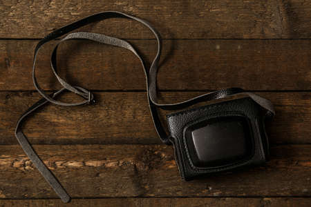 Retro photo camera on wooden surfaceの写真素材