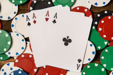 Poker cards and chips on wooden surfaceの写真素材