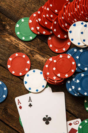 Poker cards and chips on wooden surfaceの写真素材