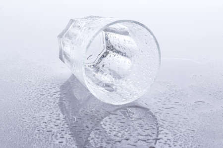 Empty glass on wet surfaceの写真素材