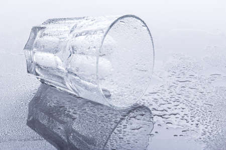 Empty glass on wet surfaceの写真素材