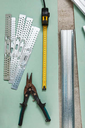 Scissors for metal and measure tape on  plasterboardの写真素材